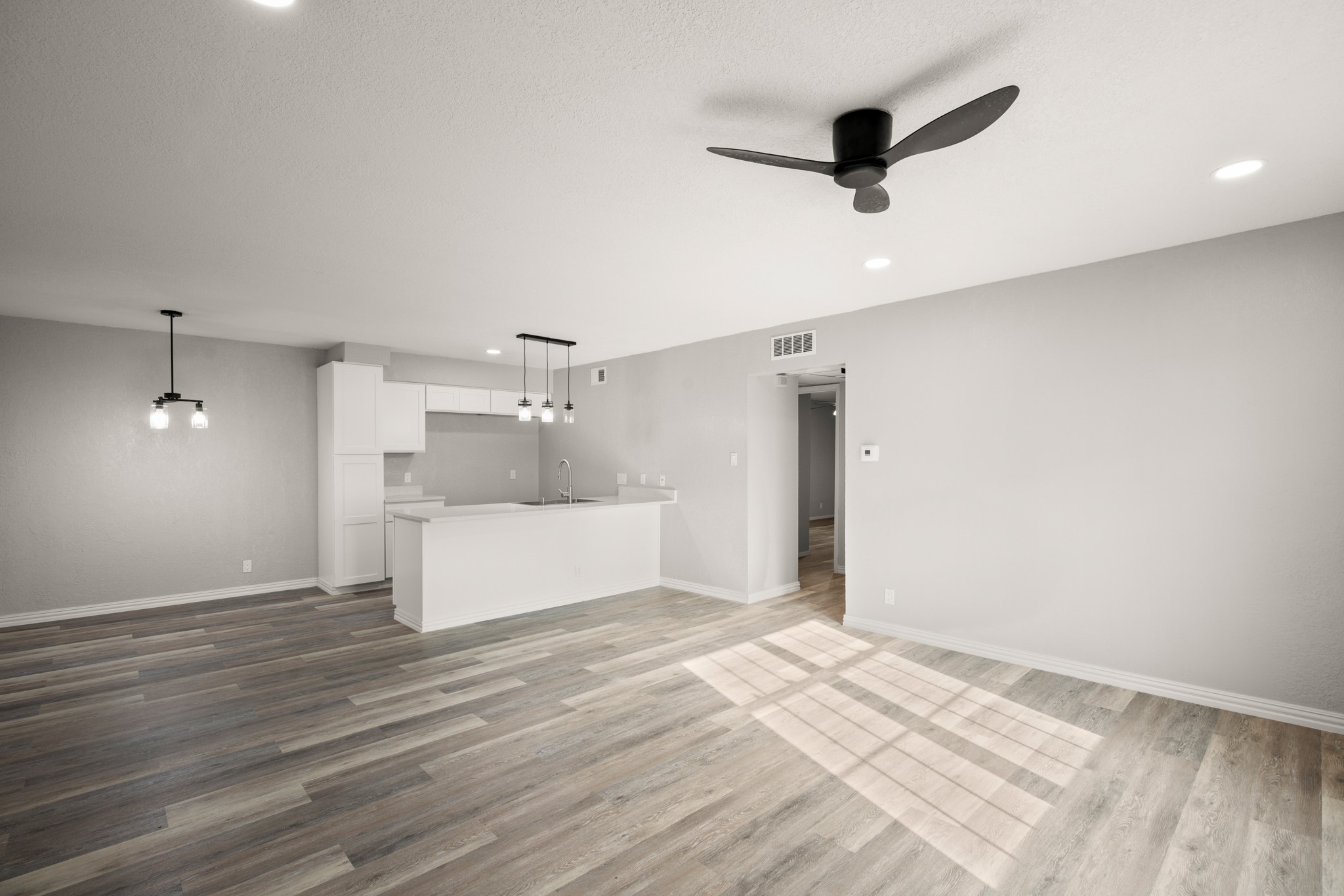 910 Duncan Lane, Unit 56 Austin, TX 78705 - Photo 2 of 17 a view of a kitchen with a sink and a refrigerator