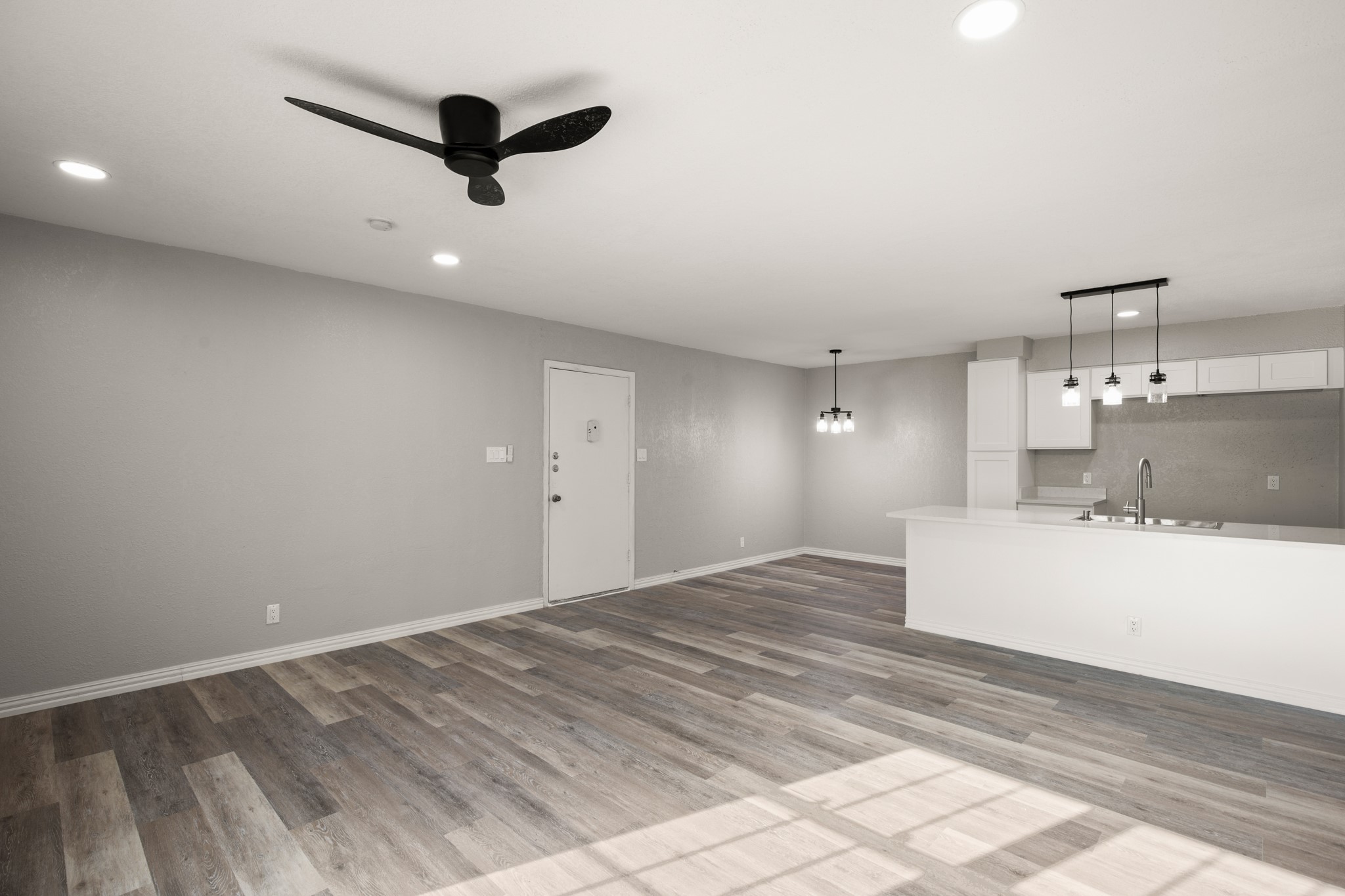 910 Duncan Lane, Unit 56 Austin, TX 78705 - Photo 3 of 17 a view of a kitchen with a sink cabinetry and a ceiling fan