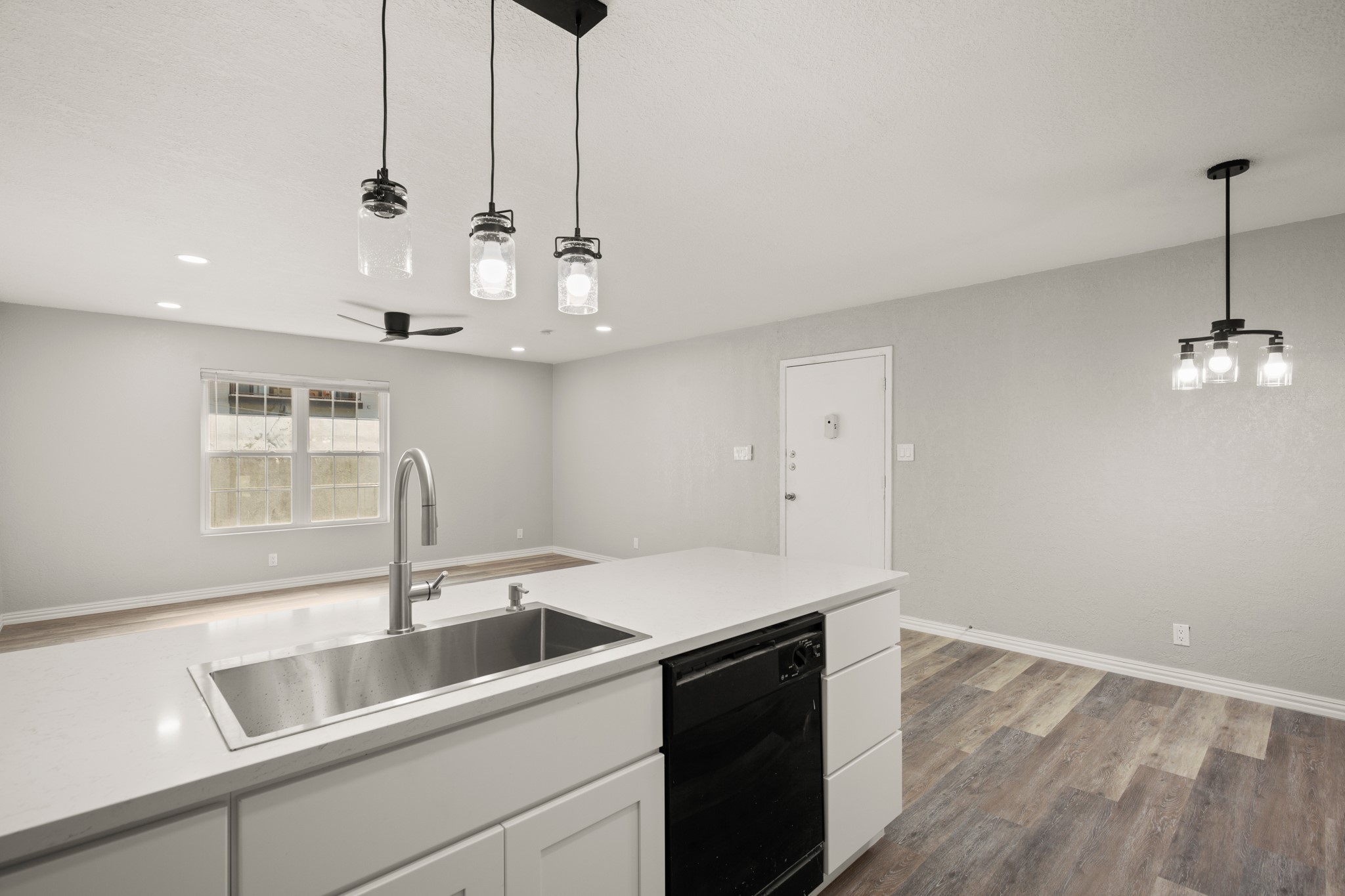 910 Duncan Lane, Unit 56 Austin, TX 78705 - Photo 6 of 17 a kitchen that has a sink a stove and a window with wooden floor