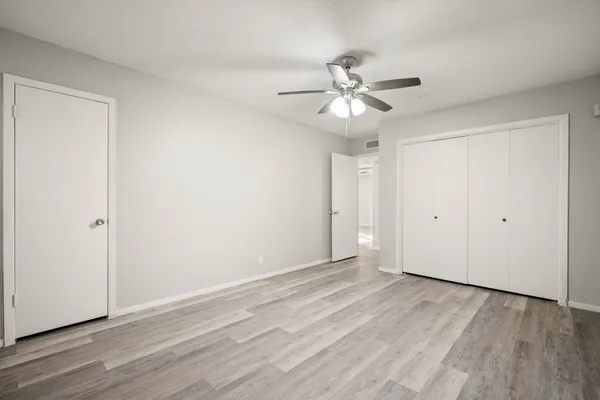 a view of an empty room with wooden floor