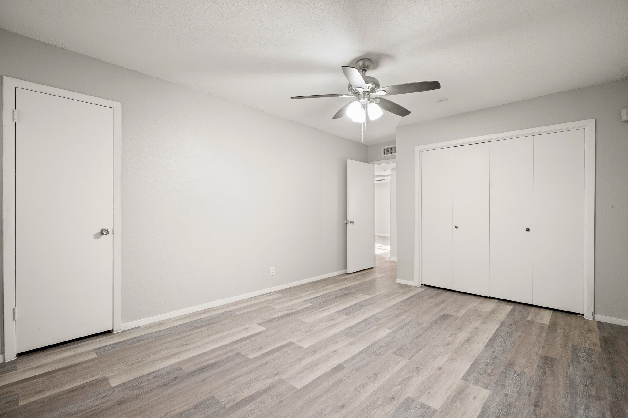 910 Duncan Lane, Unit 56 Austin, TX 78705 - Photo 10 of 17 a view of an empty room with wooden floor