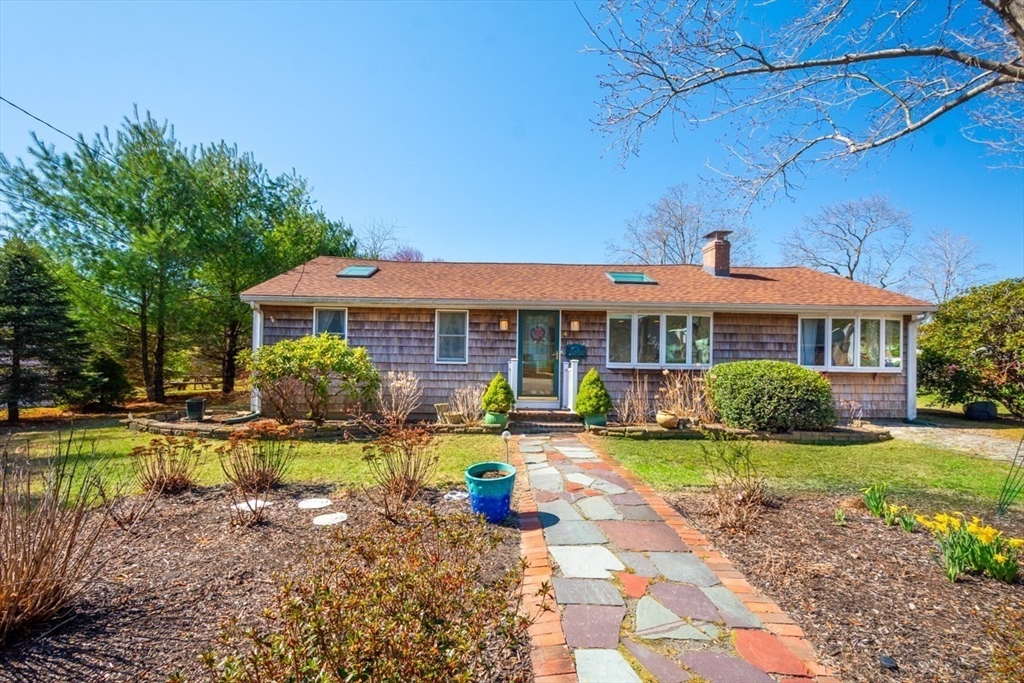 a front view of a house with swimming pool having outdoor seating