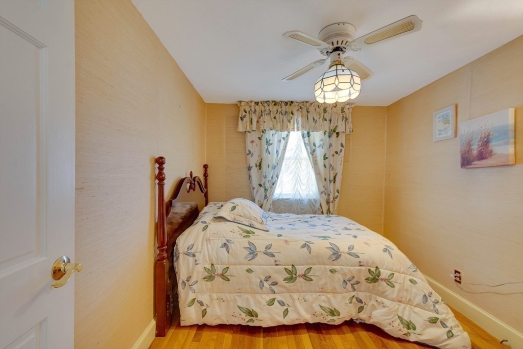 4 Worcester Road Sharon, MA 02067 - Photo 15 of 25 a view of a bedroom with wooden floor and a chandelier