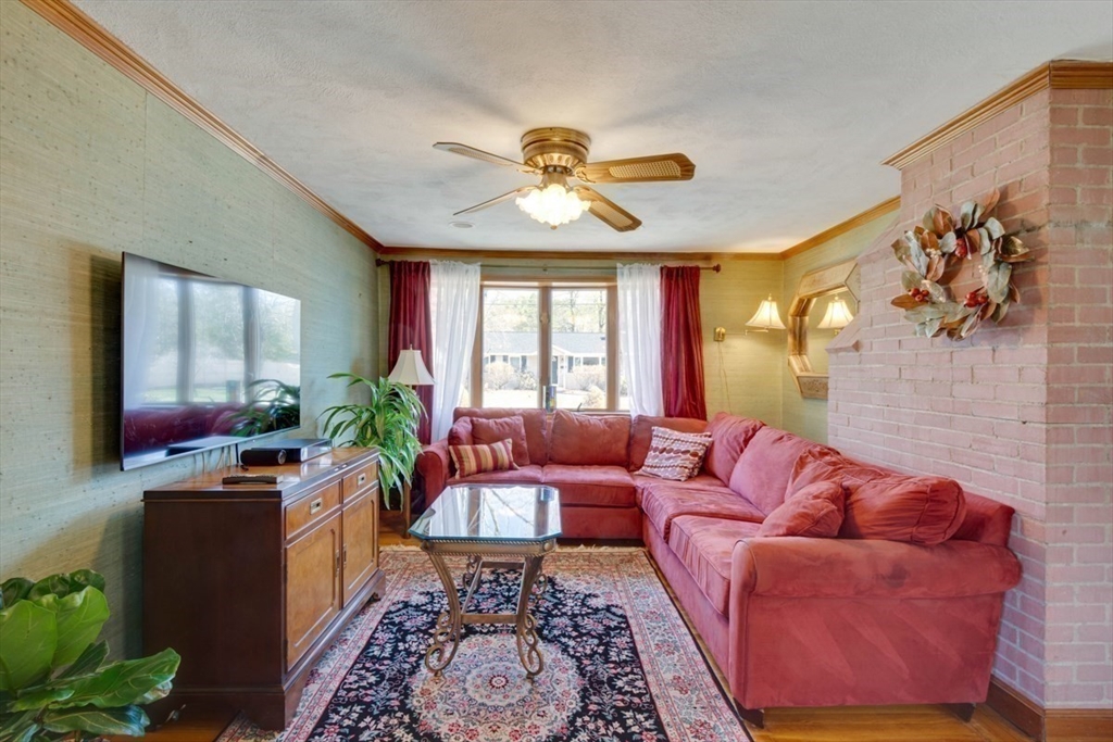 4 Worcester Road Sharon, MA 02067 - Photo 5 of 25 a living room with furniture a chandelier and a window