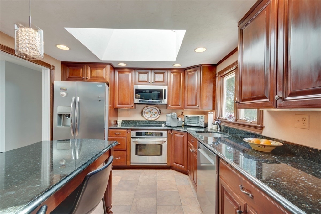 4 Worcester Road Sharon, MA 02067 - Photo 10 of 25 a kitchen with stainless steel appliances granite countertop a refrigerator a sink dishwasher a stove top oven a sink and dishwasher