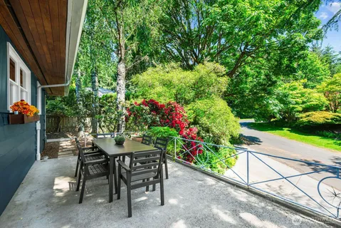a view of a backyard with furniture and a garden