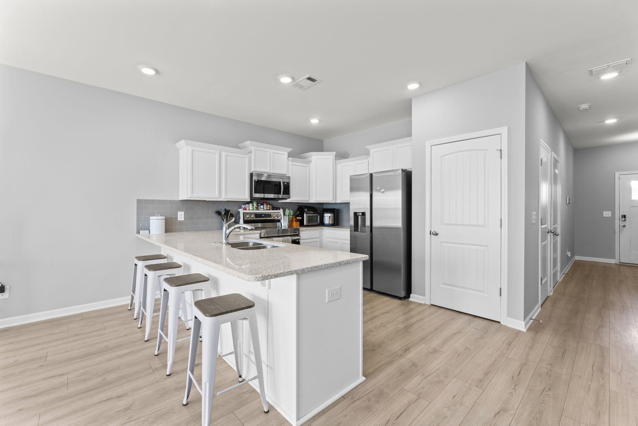 5711 Dockside Drive Rockvale, TN 37153 - Photo 8 of 30 a kitchen with stainless steel appliances a refrigerator stove a sink and a dining table with wooden floor