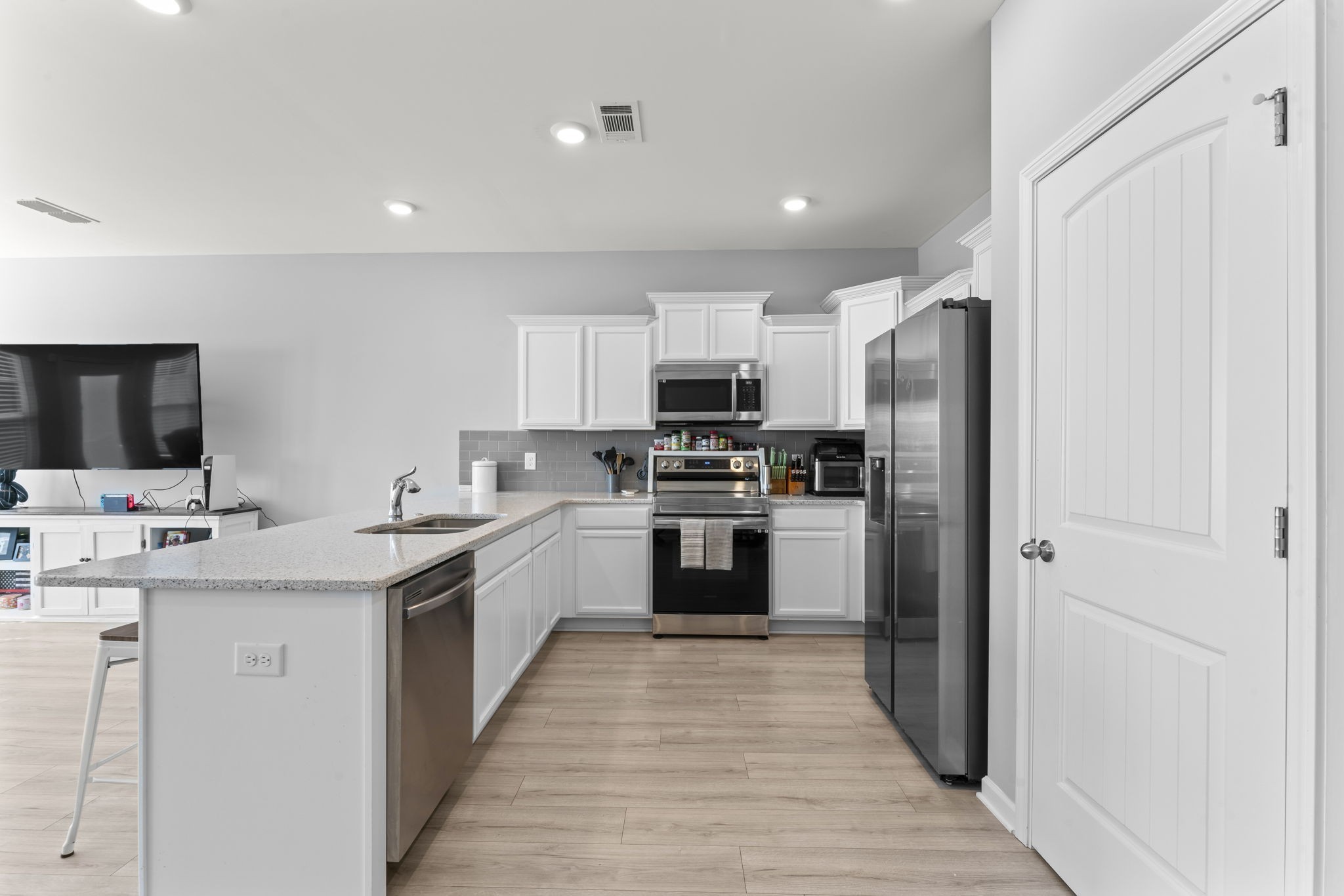 5711 Dockside Drive Rockvale, TN 37153 - Photo 9 of 30 a kitchen with white cabinets and stainless steel appliances