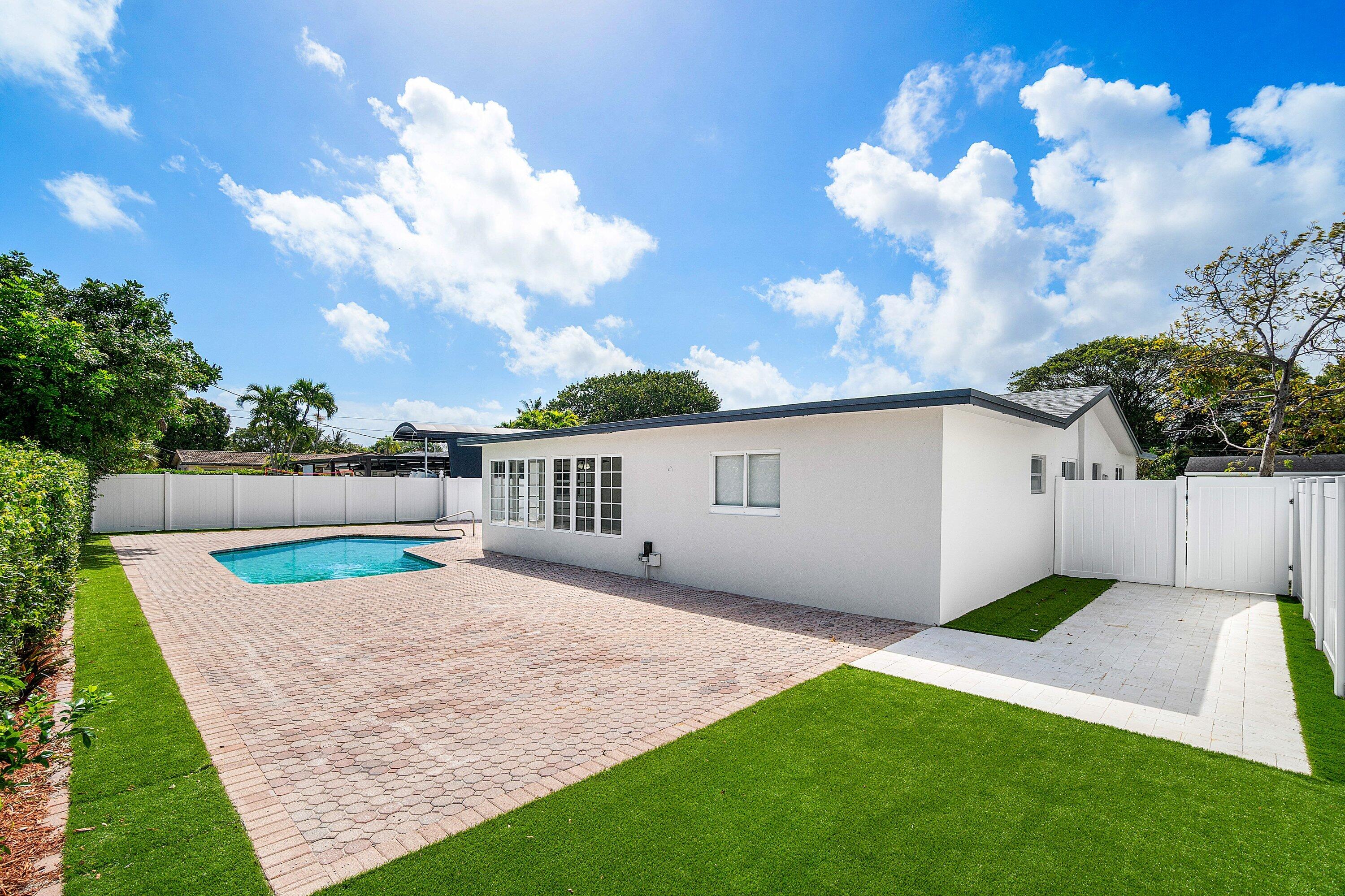1531 Northwest 4th Street Boca Raton, FL 33486 - Photo 33 of 34 a backyard of a house with table and chairs