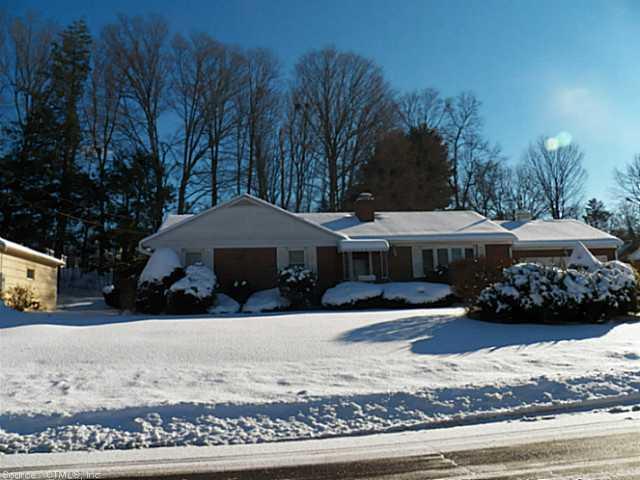 60 Beverly Road Torrington, CT 06790 - Photo 1 of 1 a front view of a house with a yard covered with snow and trees