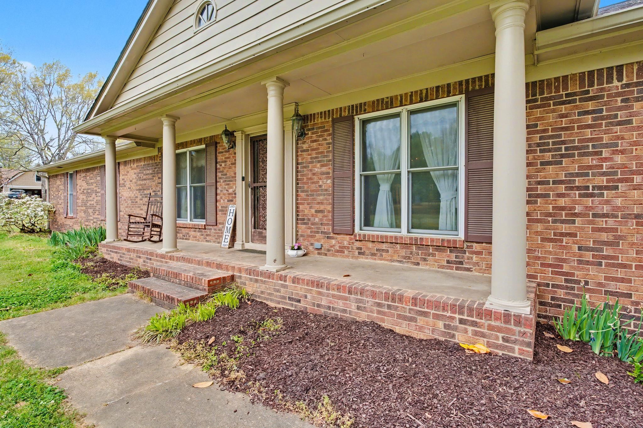 11380 Sycamore Farms Road Collierville, TN 38017 - Photo 28 of 35 Doorway to property with a porch and brick siding