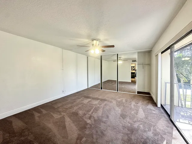 a view of a livingroom with a ceiling fan and window