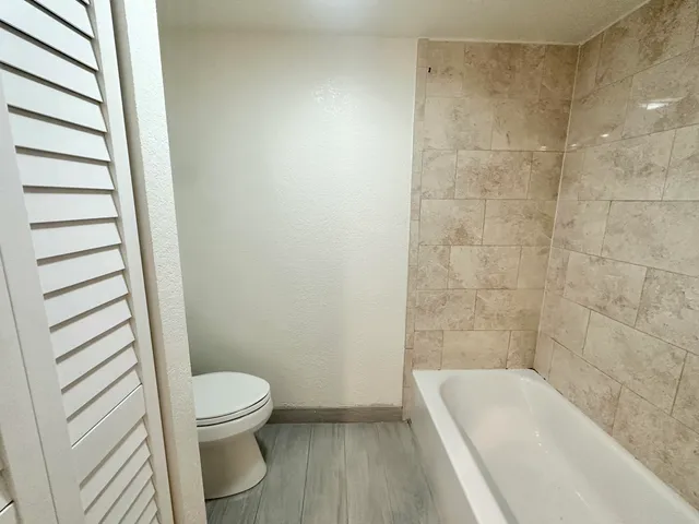 a bathroom with a bathtub and toilet