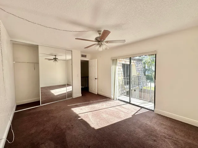 a view of a livingroom with a ceiling fan and window