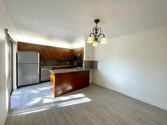 a kitchen with stainless steel appliances a refrigerator and a stove top oven