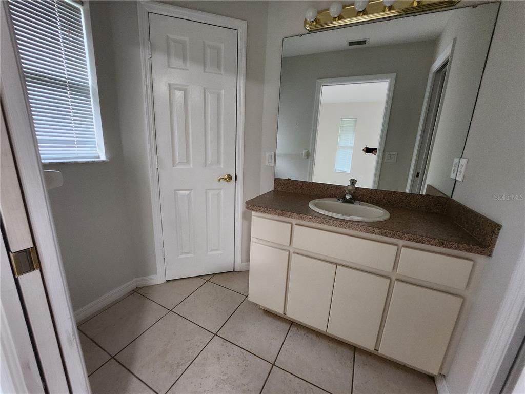 6521 East Grayson Street Inverness, FL 34452 - Photo 10 of 16 a bathroom with a sink a vanity and a mirror