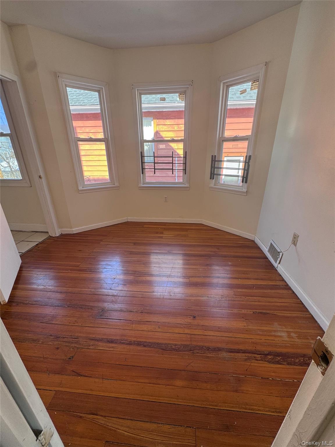 4 Gray Street, Unit #2 Poughkeepsie, NY 12603 - Photo 13 of 27 an empty room with wooden floor and windows