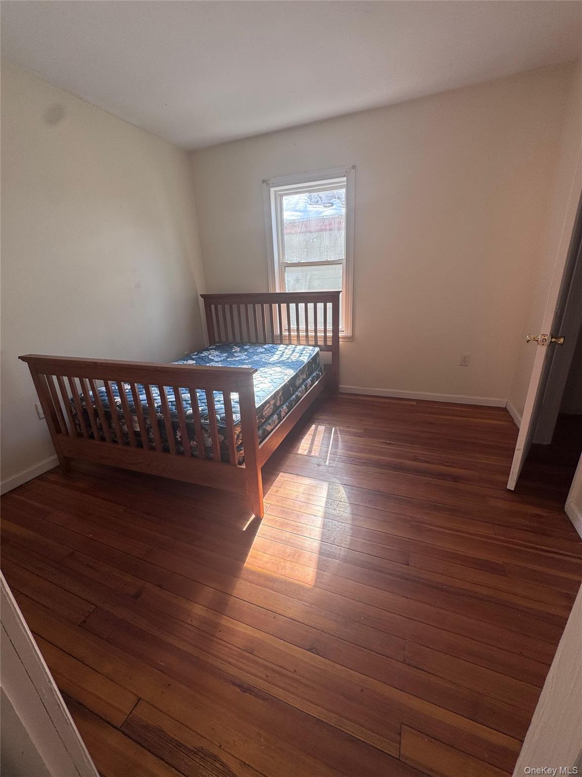 4 Gray Street, Unit #2 Poughkeepsie, NY 12603 - Photo 16 of 27 a view of a livingroom with wooden floor and a window