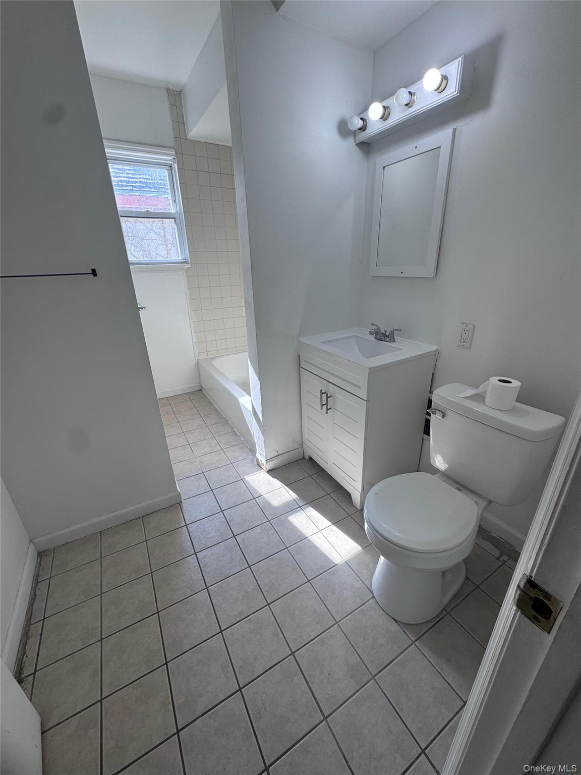 4 Gray Street, Unit #2 Poughkeepsie, NY 12603 - Photo 18 of 27 a bathroom with a toilet a sink and mirror