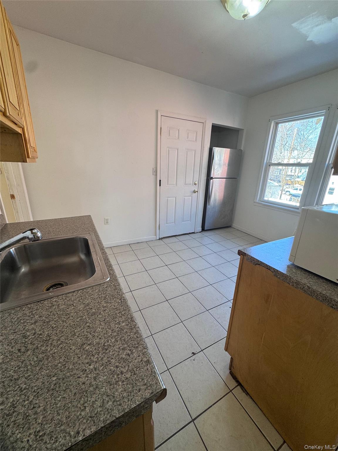 4 Gray Street, Unit #2 Poughkeepsie, NY 12603 - Photo 22 of 27 a living room with a couch and a stove next to a window