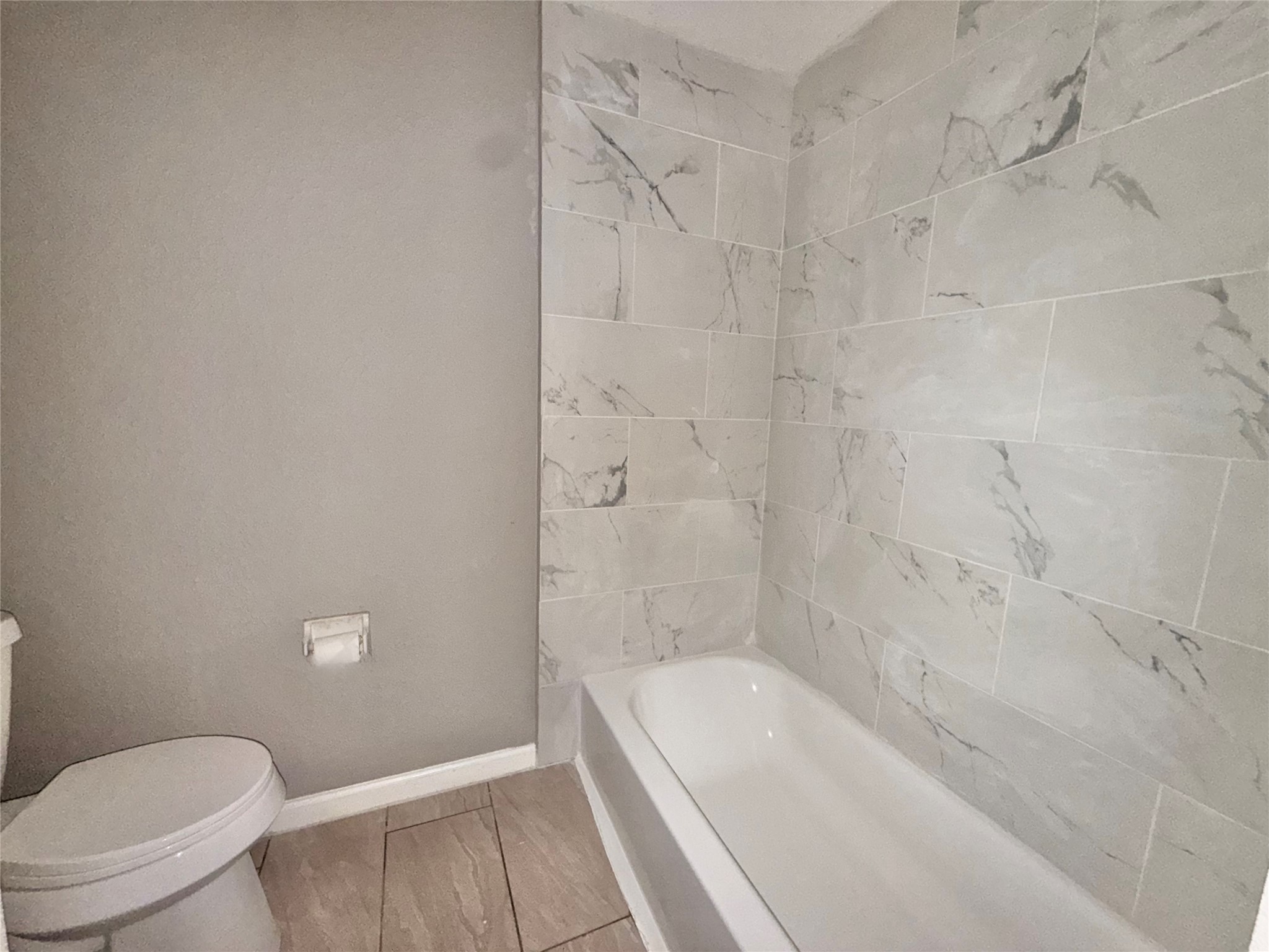 5418 Weaver Road, Unit D Houston, TX 77016 - Photo 7 of 12 a bathroom with a granite countertop bathtub shower and toilet