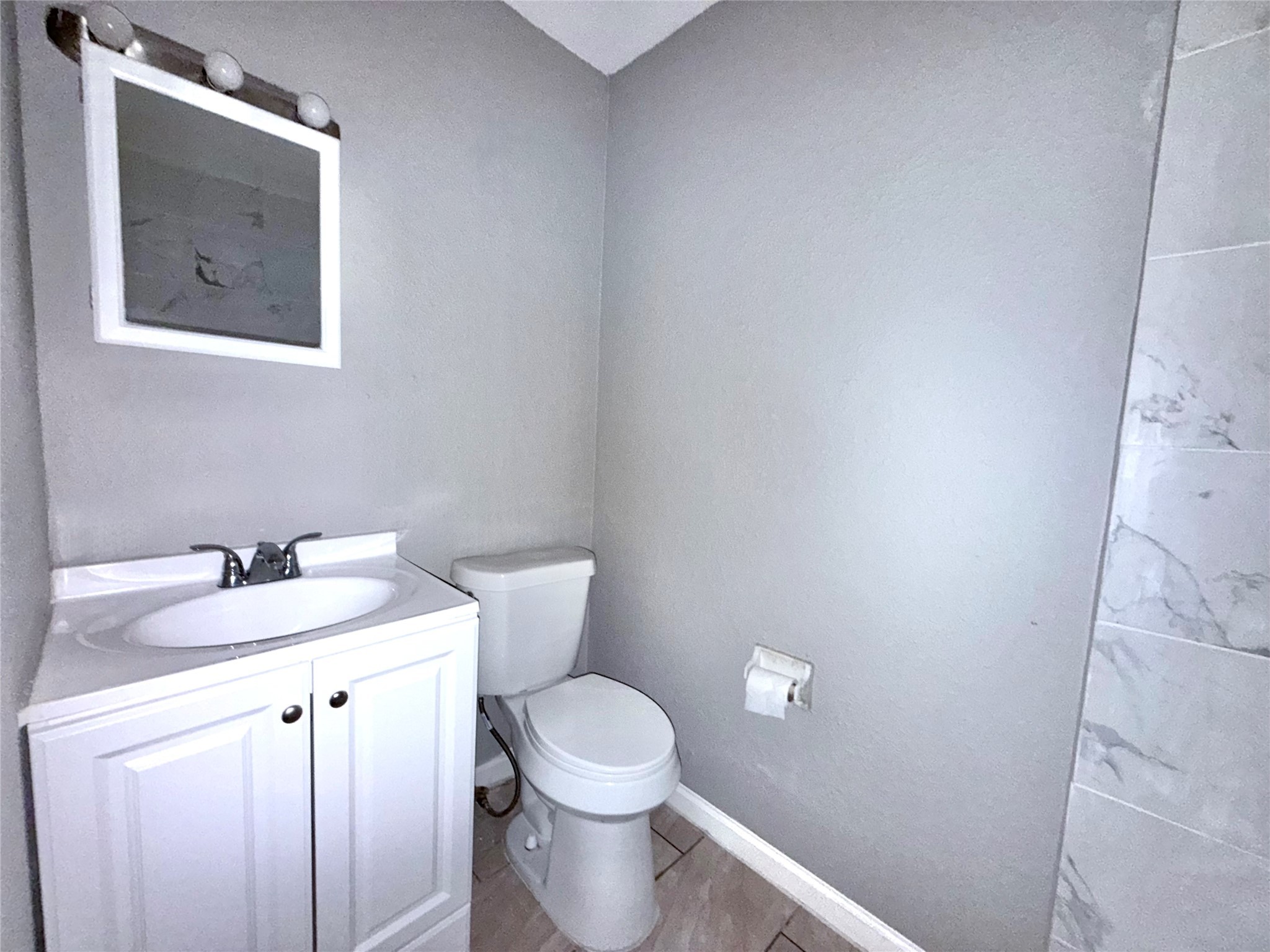 5418 Weaver Road, Unit D Houston, TX 77016 - Photo 8 of 12 a bathroom with a toilet sink and mirror