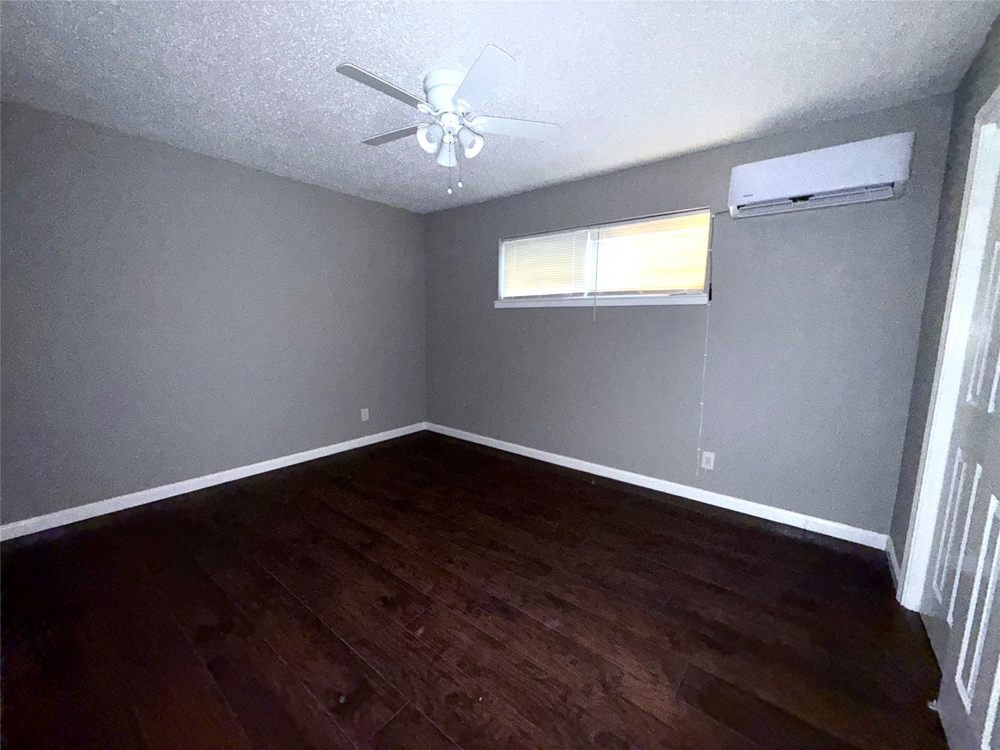5418 Weaver Road, Unit D Houston, TX 77016 - Photo 10 of 12 a view of an empty room with wooden floor and a window