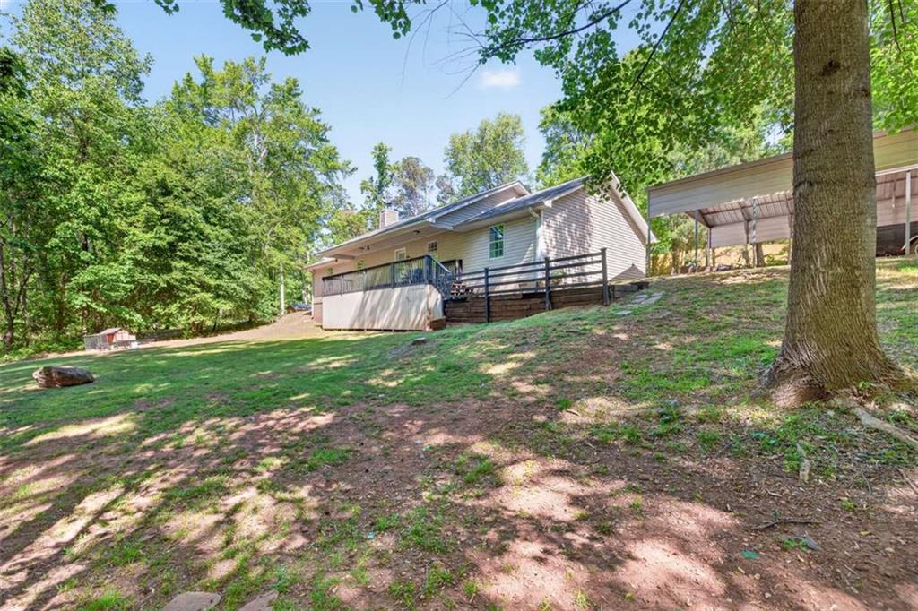 386 Ridgewood Drive Pendergrass, GA 30567 - Photo 30 of 50 a house with green field in front of it