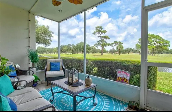 a view of a porch with furniture and garden