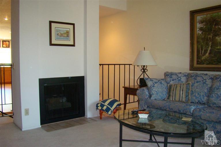 19515 Rinaldi Street, Unit 54 Northridge, CA 91326 - Photo 2 of 20 a living room with furniture and a fireplace