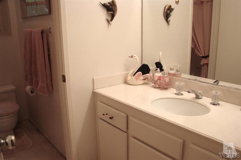 19515 Rinaldi Street, Unit 54 Northridge, CA 91326 - Photo 11 of 20 a bathroom with a sink and a mirror