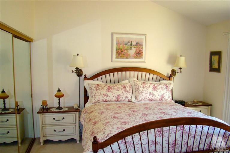 19515 Rinaldi Street, Unit 54 Northridge, CA 91326 - Photo 12 of 20 a bedroom with a bed and wooden floor