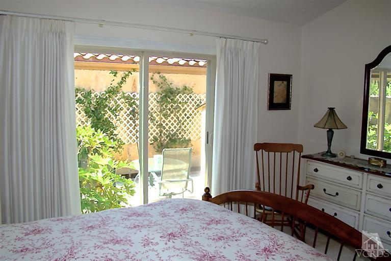 19515 Rinaldi Street, Unit 54 Northridge, CA 91326 - Photo 13 of 20 a view of a bedroom with a bed and a window