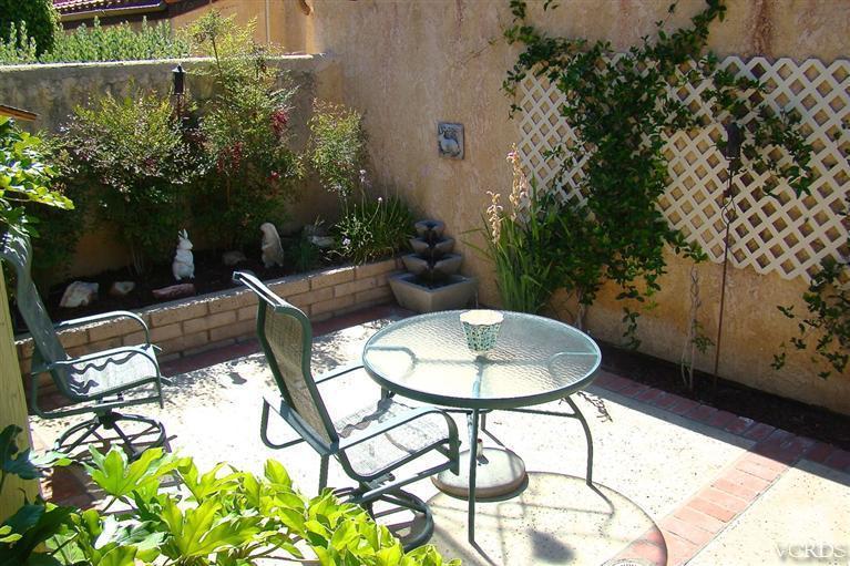 19515 Rinaldi Street, Unit 54 Northridge, CA 91326 - Photo 14 of 20 a backyard of a house with table and chairs