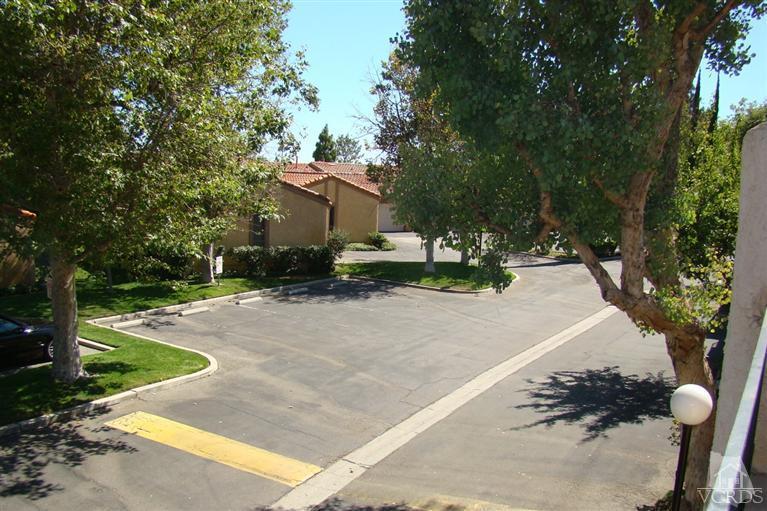 19515 Rinaldi Street, Unit 54 Northridge, CA 91326 - Photo 18 of 20 a view of a house with a yard and tree s