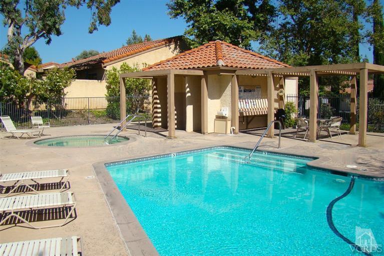 19515 Rinaldi Street, Unit 54 Northridge, CA 91326 - Photo 19 of 20 a view of a house with a backyard patio and swimming pool