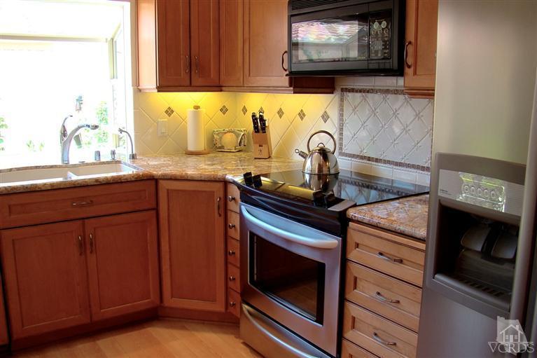 19515 Rinaldi Street, Unit 54 Northridge, CA 91326 - Photo 5 of 20 a kitchen with granite countertop a stove and a sink