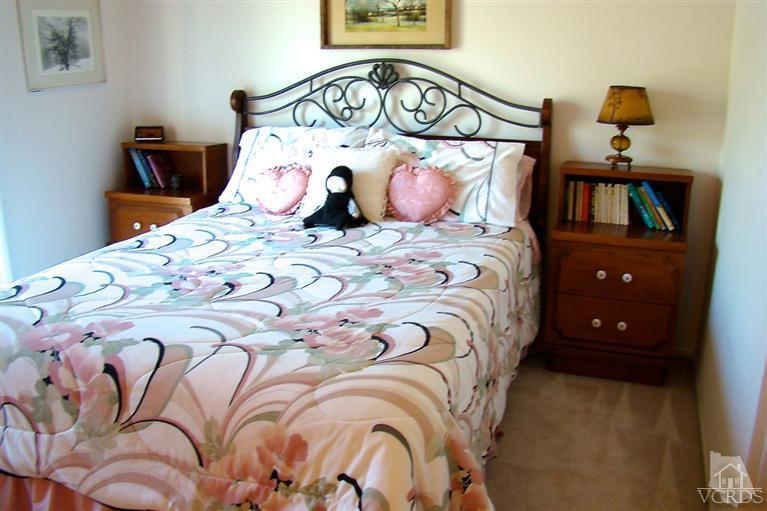 19515 Rinaldi Street, Unit 54 Northridge, CA 91326 - Photo 10 of 20 a bedroom with a bed and a painting on the wall