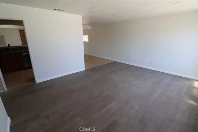 an empty room with wooden floor