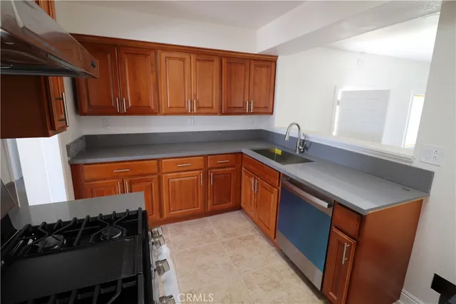 a kitchen with a sink stove and cabinets