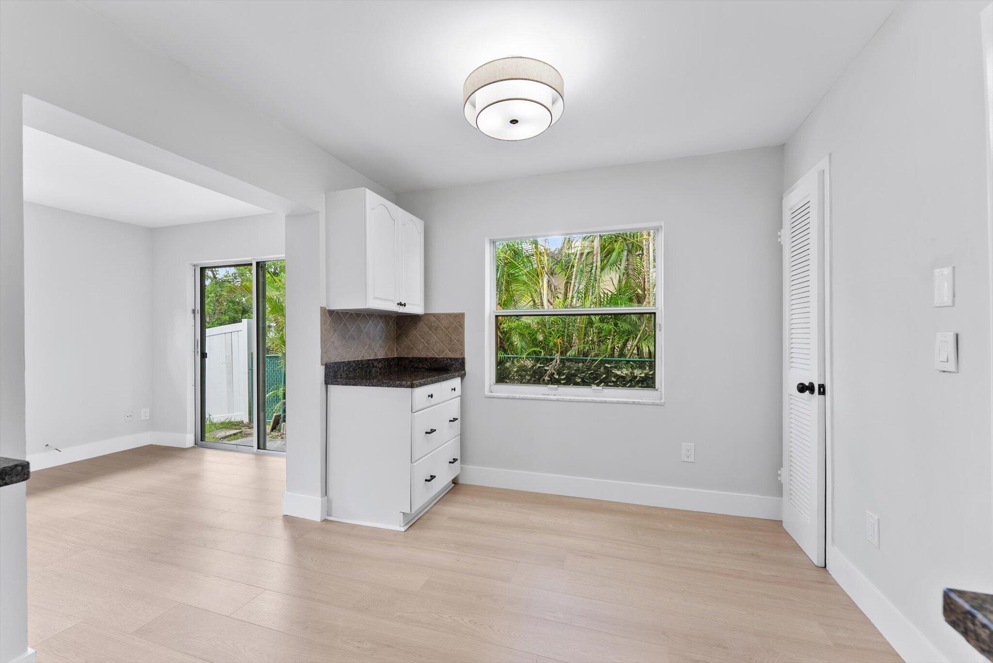 22267 Southwest 57th Avenue Boca Raton, FL 33428 - Photo 13 of 30 a view of a kitchen with furniture and a window