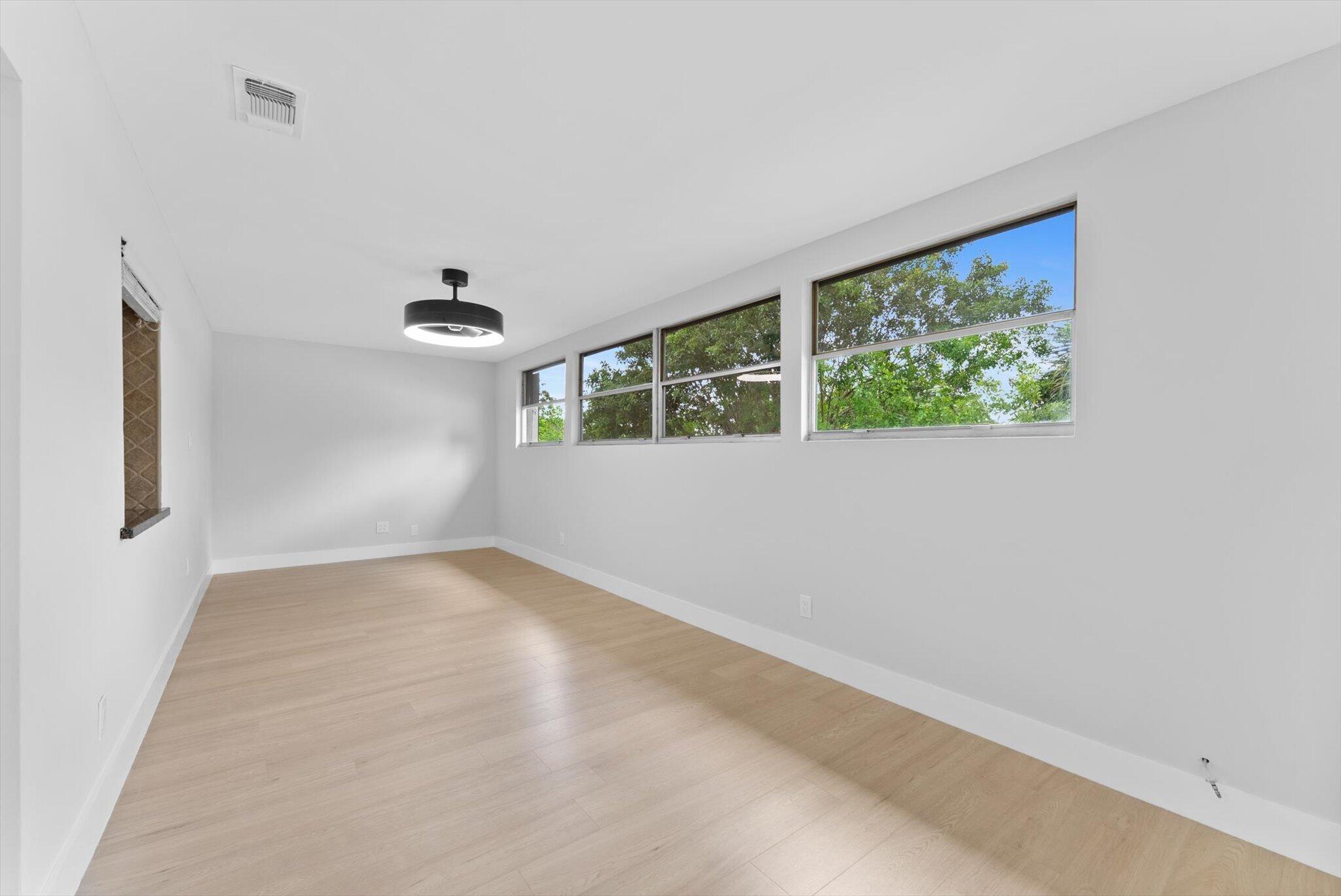 22267 Southwest 57th Avenue Boca Raton, FL 33428 - Photo 14 of 30 an empty room with windows