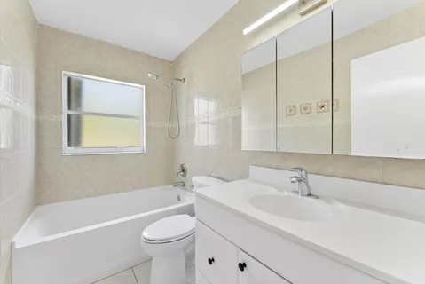a bathroom with a sink a toilet and a bathtub