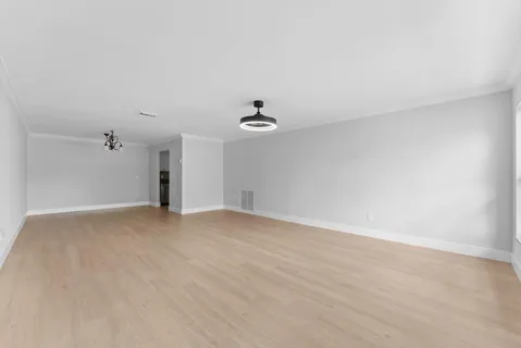 a view of empty room with ceiling fan