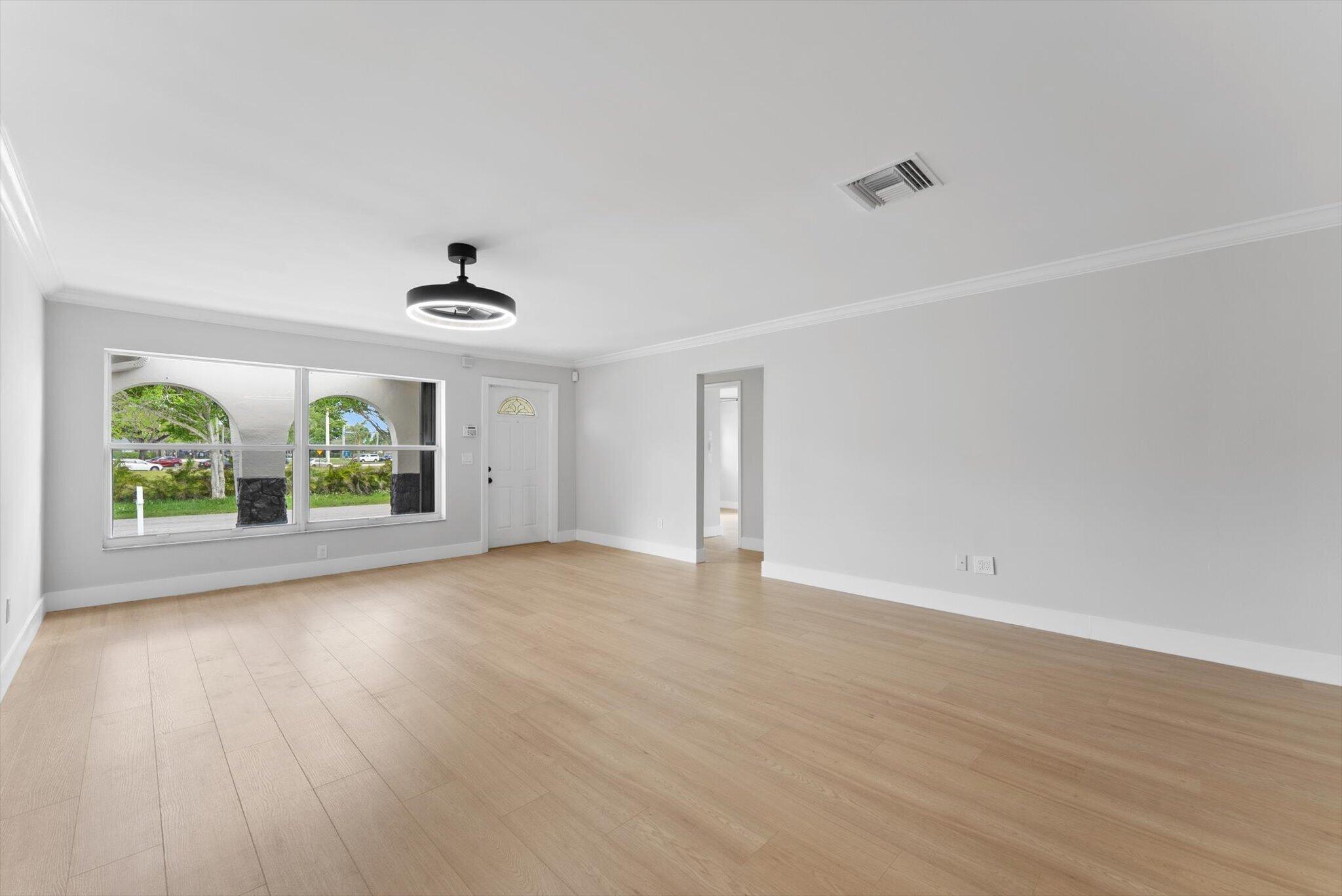 22267 Southwest 57th Avenue Boca Raton, FL 33428 - Photo 7 of 30 wooden floor in an empty room with a window