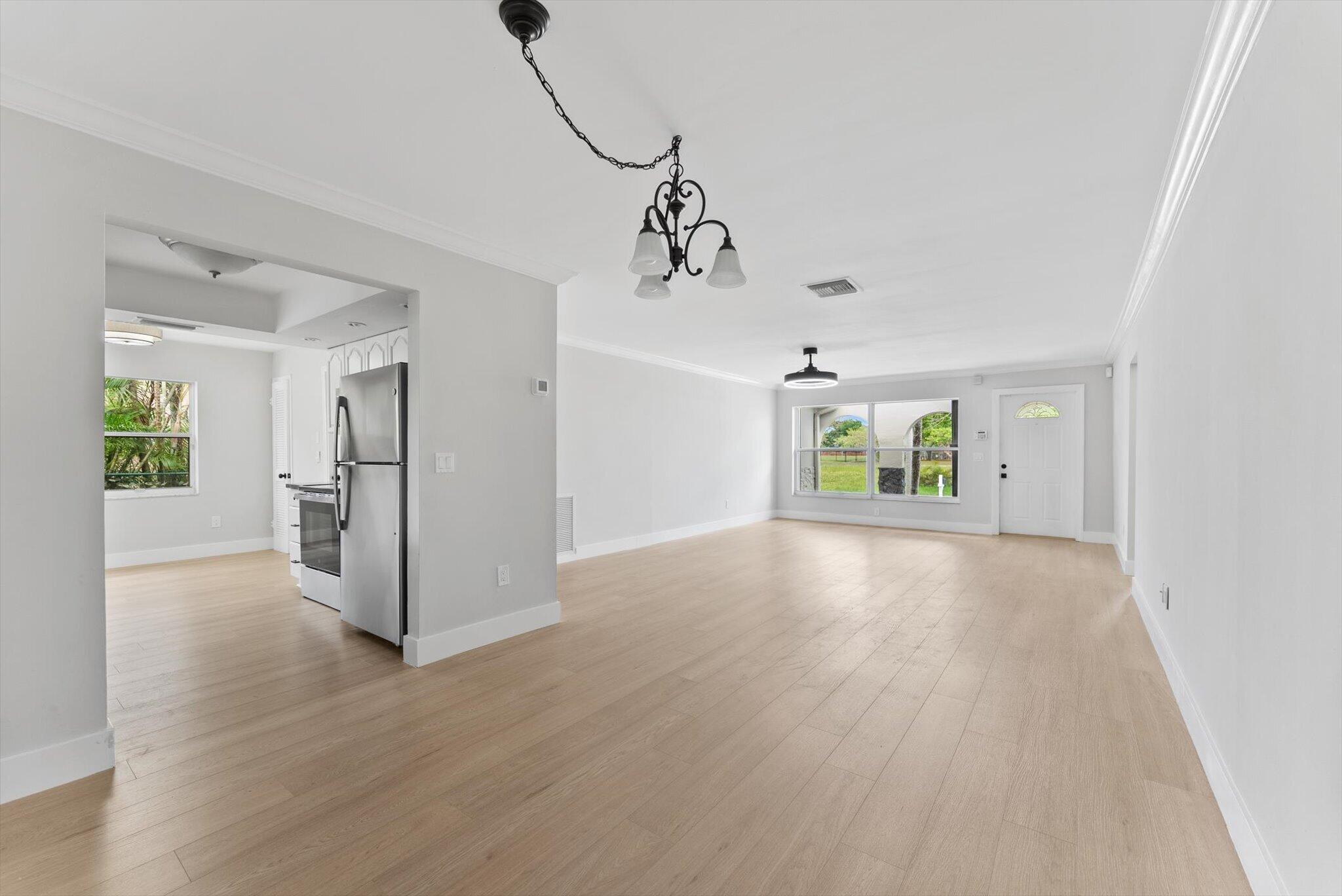 22267 Southwest 57th Avenue Boca Raton, FL 33428 - Photo 9 of 30 a view interior of a house wooden floor and windows