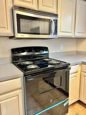 a stove top oven sitting inside of a kitchen