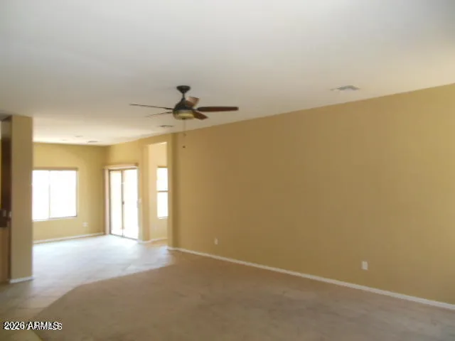 a view of a livingroom with a ceiling fan and window