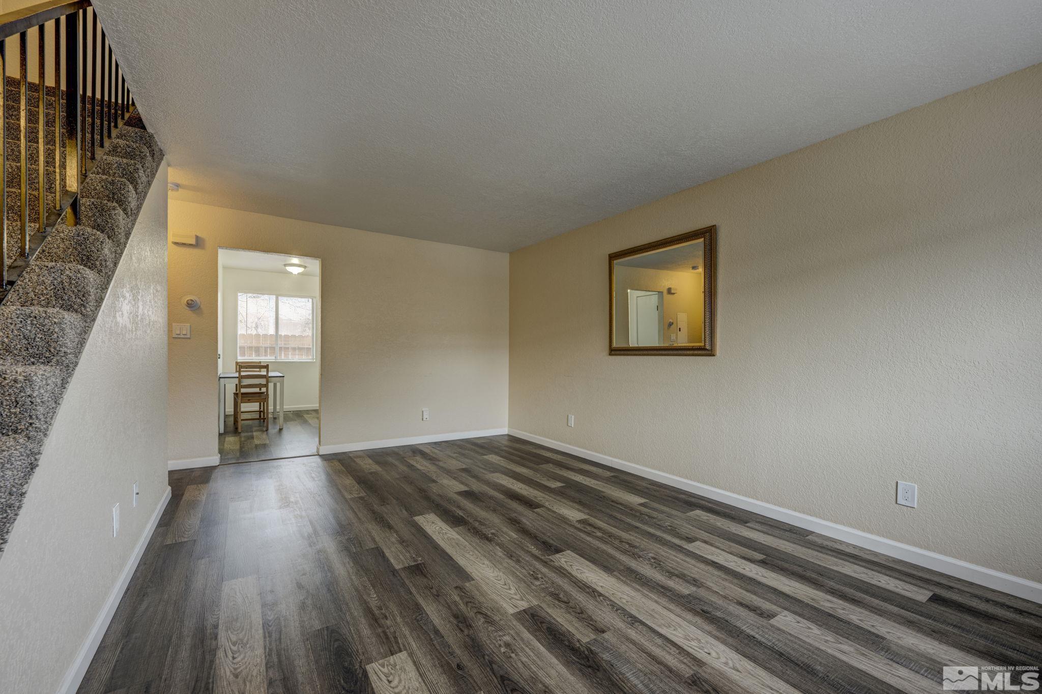 1424 East 9th Street, Unit 3 Reno, NV 89512 - Photo 3 of 26 wooden floor in an empty room with a window