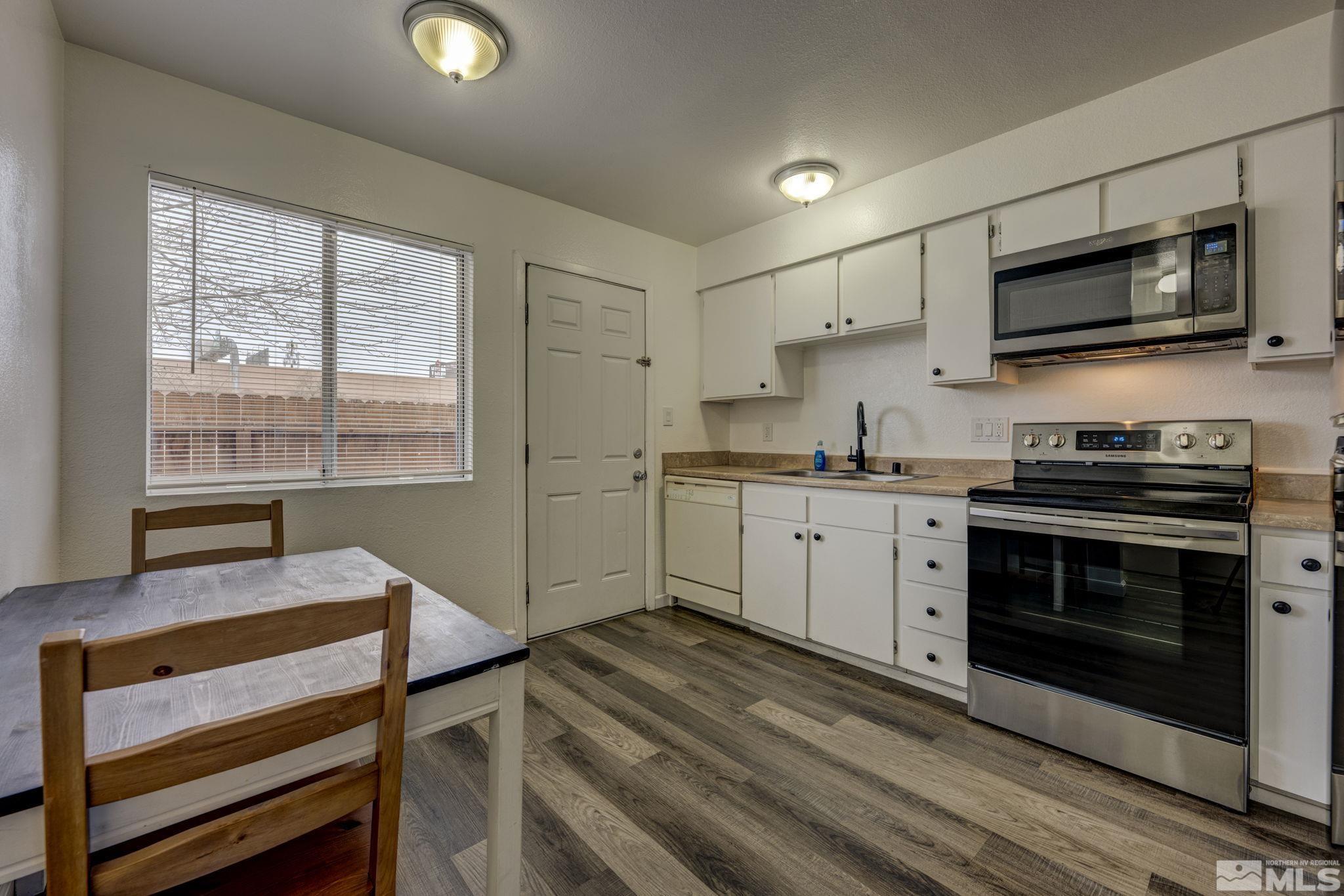 1424 East 9th Street, Unit 3 Reno, NV 89512 - Photo 5 of 26 a kitchen with a stove and a microwave